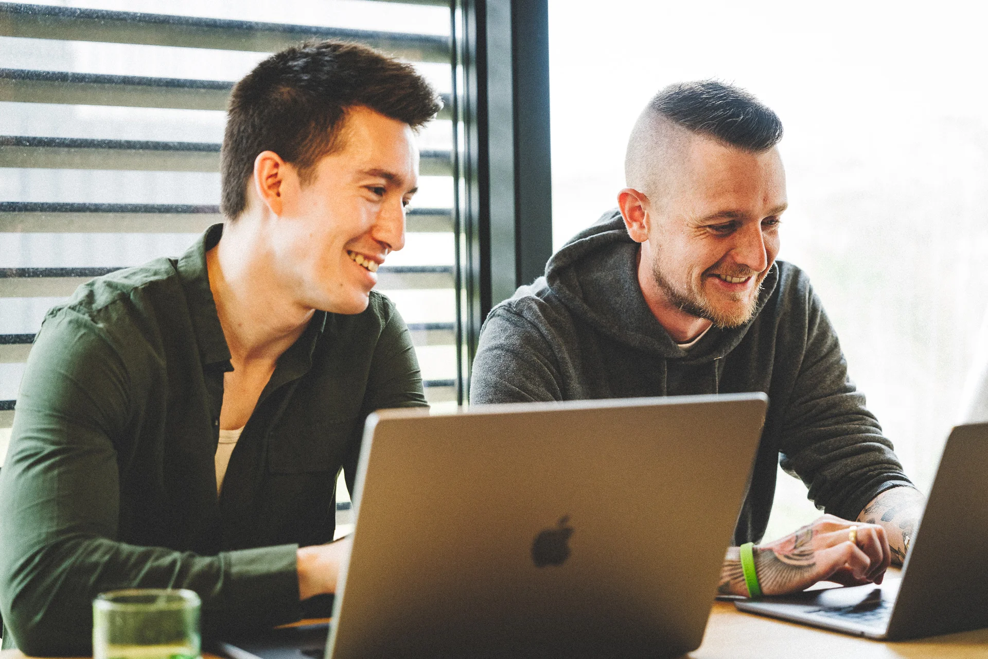 Two colleagues collaborating at a laptop