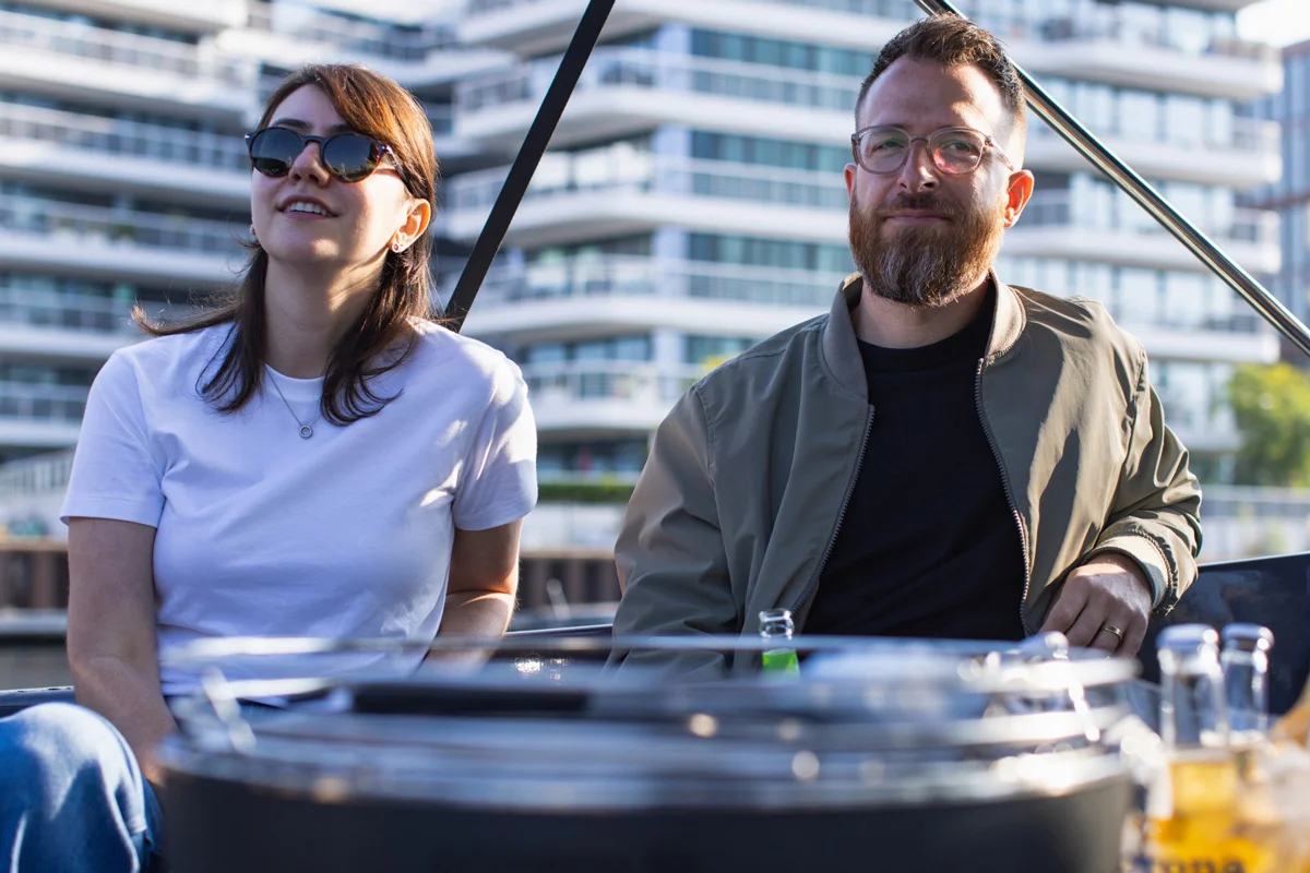 Two colleagues enjoying a rooftop moment in the sun